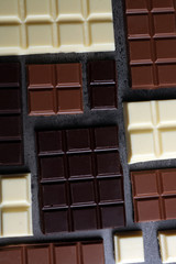 Different chocolate pieces on gray background