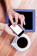Businesswoman using her smartphone on desk