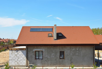 Fototapeta na wymiar Beautiful New Building House Energy Efficiency Solution Concept Outdoor. Solar Energy, Solar Water Heater, Rain Gutter, Skylights, Installed on Ceramic Red Tiled Roof Exterior. Plastering Facade Wall