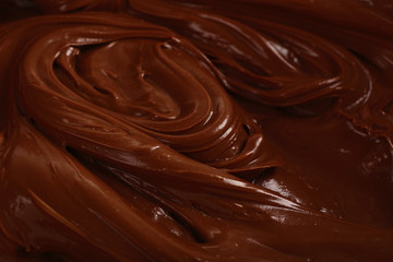 Background of thick melted milk chocolate, close-up