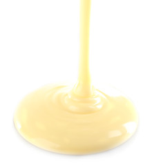 Melted white chocolate pouring, isolated