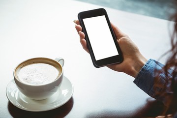 Woman taking a photo of her coffee