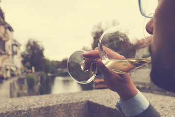 Young man drinking wine outdoors.