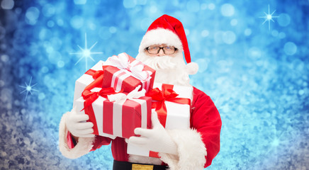 man in costume of santa claus with gift boxes