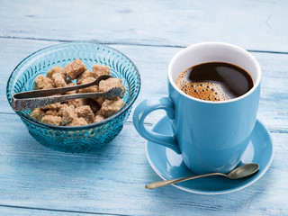 Cup of coffee and cane sugar cubes.