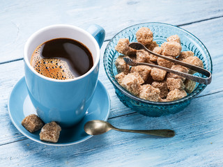 Cup of coffee and cane sugar cubes.