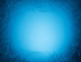 Frosty patterns on the edge of a frozen window.