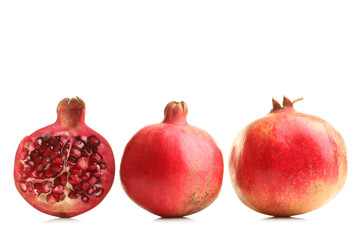 very juicy and big and delicious pomegranate in the section on white isolated background