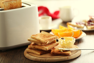 Served table for breakfast with toast and coffee, on blurred background