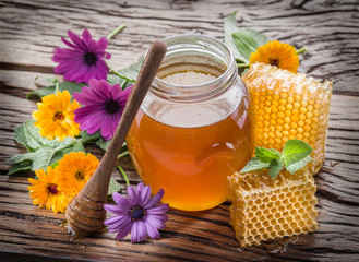 Jar full of fresh honey and honeycombs. High-quality picture.