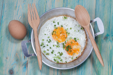 Egg in pan on wood table