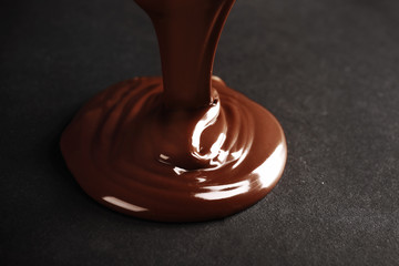 Chocolate poured on dark surface
