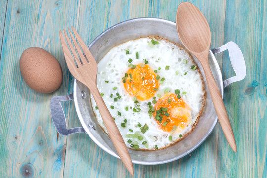 Egg in pan on wood table