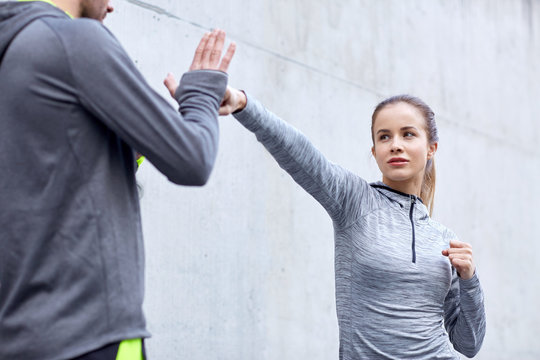 woman with coach working out strike outdoors