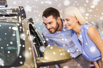 Fototapeta na wymiar happy couple buying car in auto show or salon