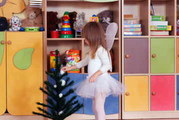 Tree-year girl playing and learning in preschool