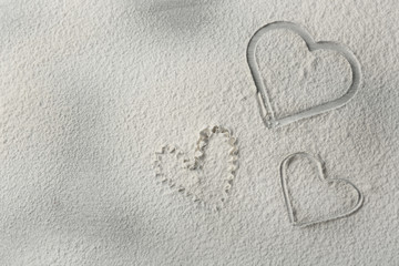 Fototapeta premium Hearts of flour on wooden background