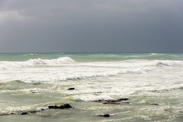 Sunlight over stormy waves