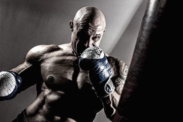 Fototapeta na wymiar Strong muscular boxer in training