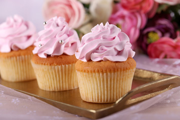 Tasty cupcakes on light background