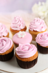 Tasty cupcakes on stand, close-up