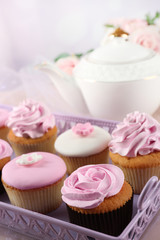 Tasty cupcakes on tray, close-up