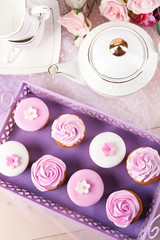 Tasty cupcakes on tray, close-up