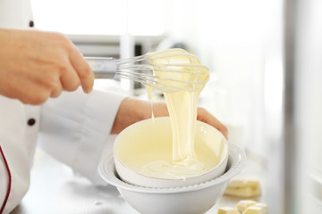 Cooking buttery cream on kitchen