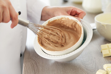 Cooking chocolate cream on kitchen