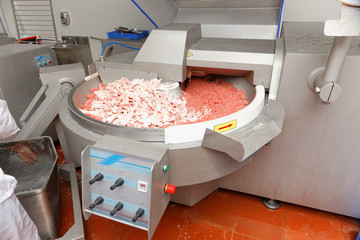 minced meat in a factory meat grinder