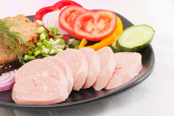 Sliced sausages with bread and tomato