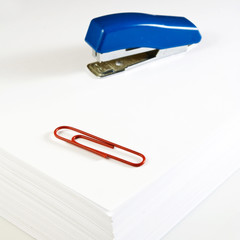 stacks of paper, stapler and clips closeup