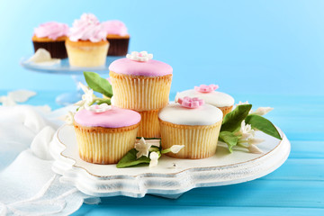 Tasty cupcakes on color wooden background