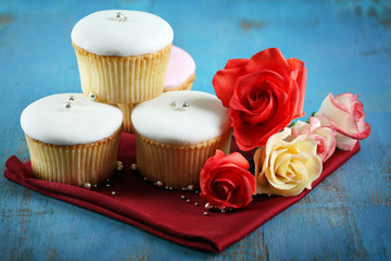 Tasty cupcakes on color wooden background
