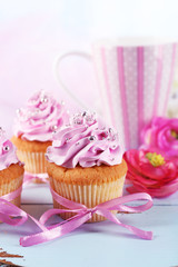 Tasty cupcakes on tray, on light background