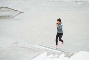 Woman running and climbing stairs