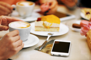 Woman with a tablet and coffee in cafe