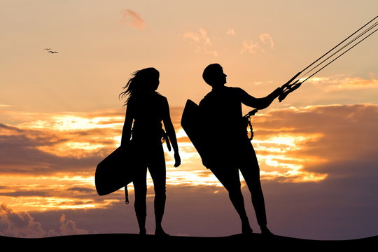 surfers couple at sunset