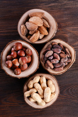Assortment of tasty nuts on wooden background