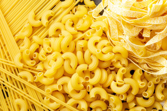 raw homemade italian pasta, macaroni, spaghetti, and fettucine