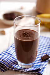 Glass of chocolate milk on table close-up