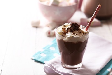 Glass of chocolate milk on table close-up