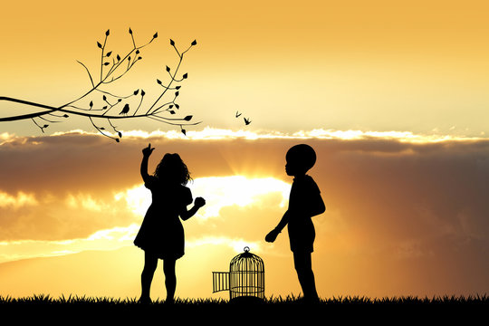 children with bird cage at sunset