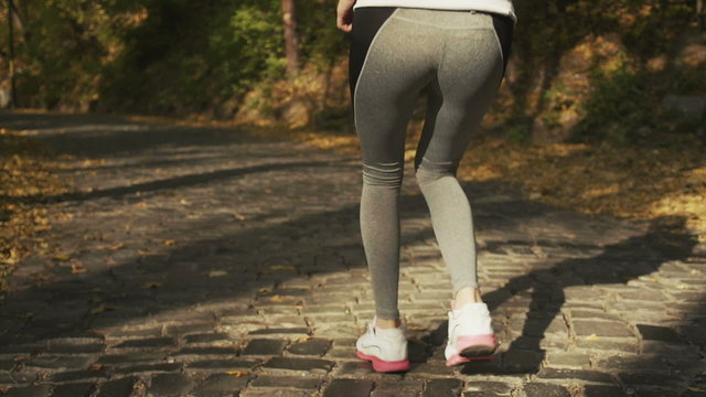 Hamstring sprain or cramps. Running sports injury with female runner. Closeup of woman back thigh.