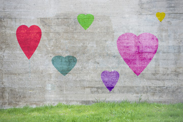 Concrete urban wall with painted hearts