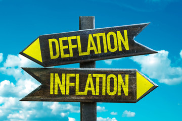 Deflation - Inflation signpost with sky background
