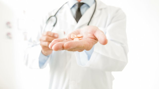 Doctor showing special pills. 