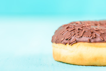 Chocolate Donut With Sparkles On Blue Background