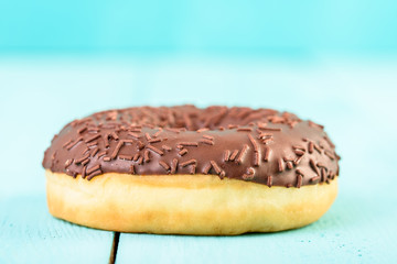 Chocolate Donut With Sparkles On Blue Background