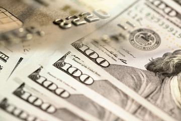 one hundred US dollar bills and credit card